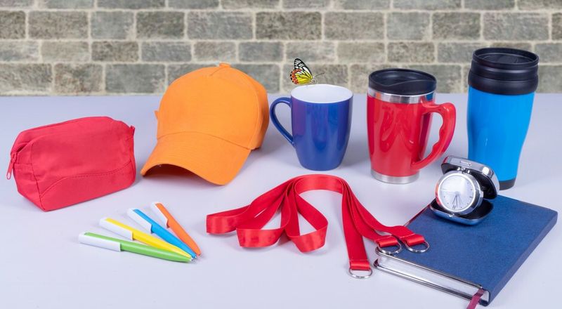 Custom branded promotional products including hats, mugs, and pens